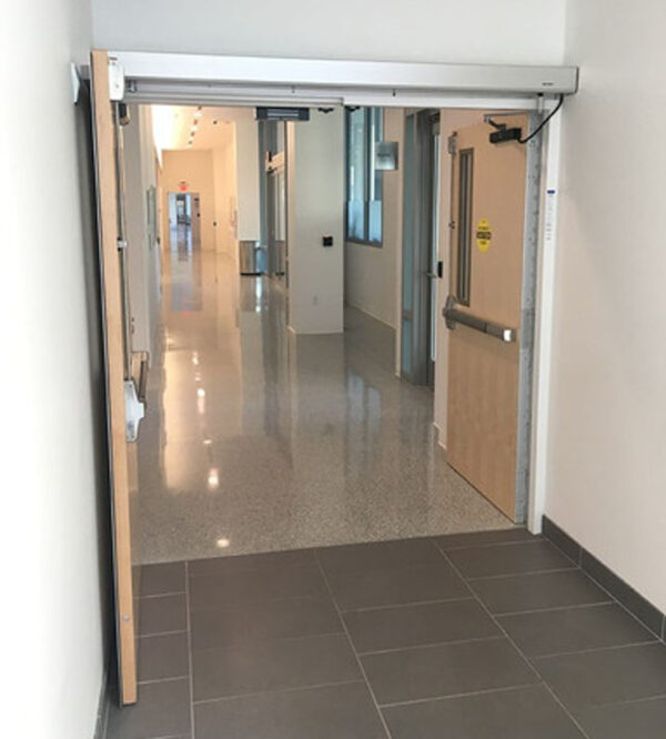 Double wood doors with automatic openers and push bars